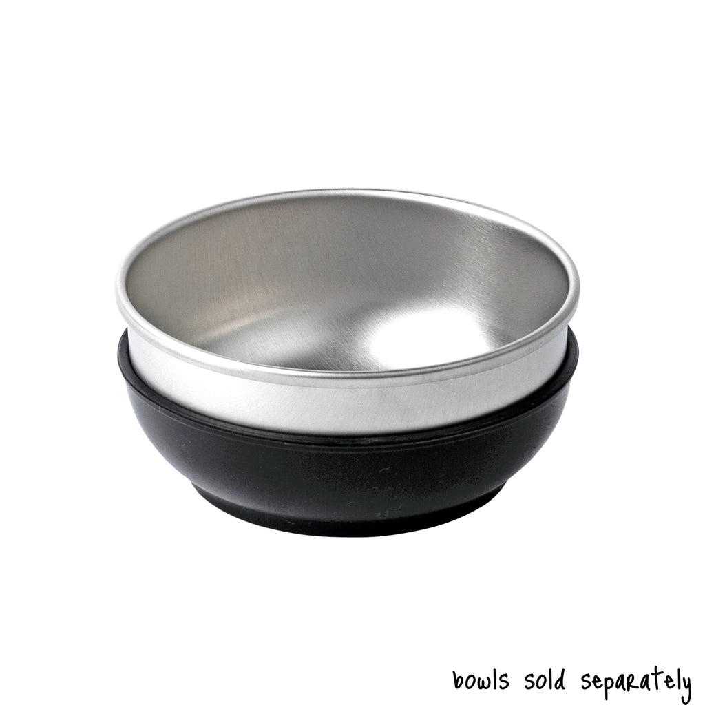 A single medium size Basis Pet stainless steel dog bowl in a black colored bowl cozy. Text reads "bowls sold separately".