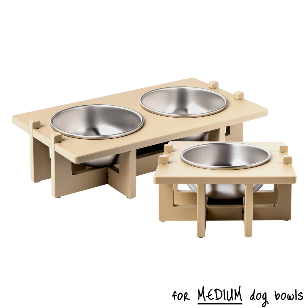 A double bowl Rise Pet Bowl Stand for medium dog bowls in the background and a single bowl Rise Pet Bowl Stand for medium dog bowls in the foreground. Text reads "for medium dog bowls".
