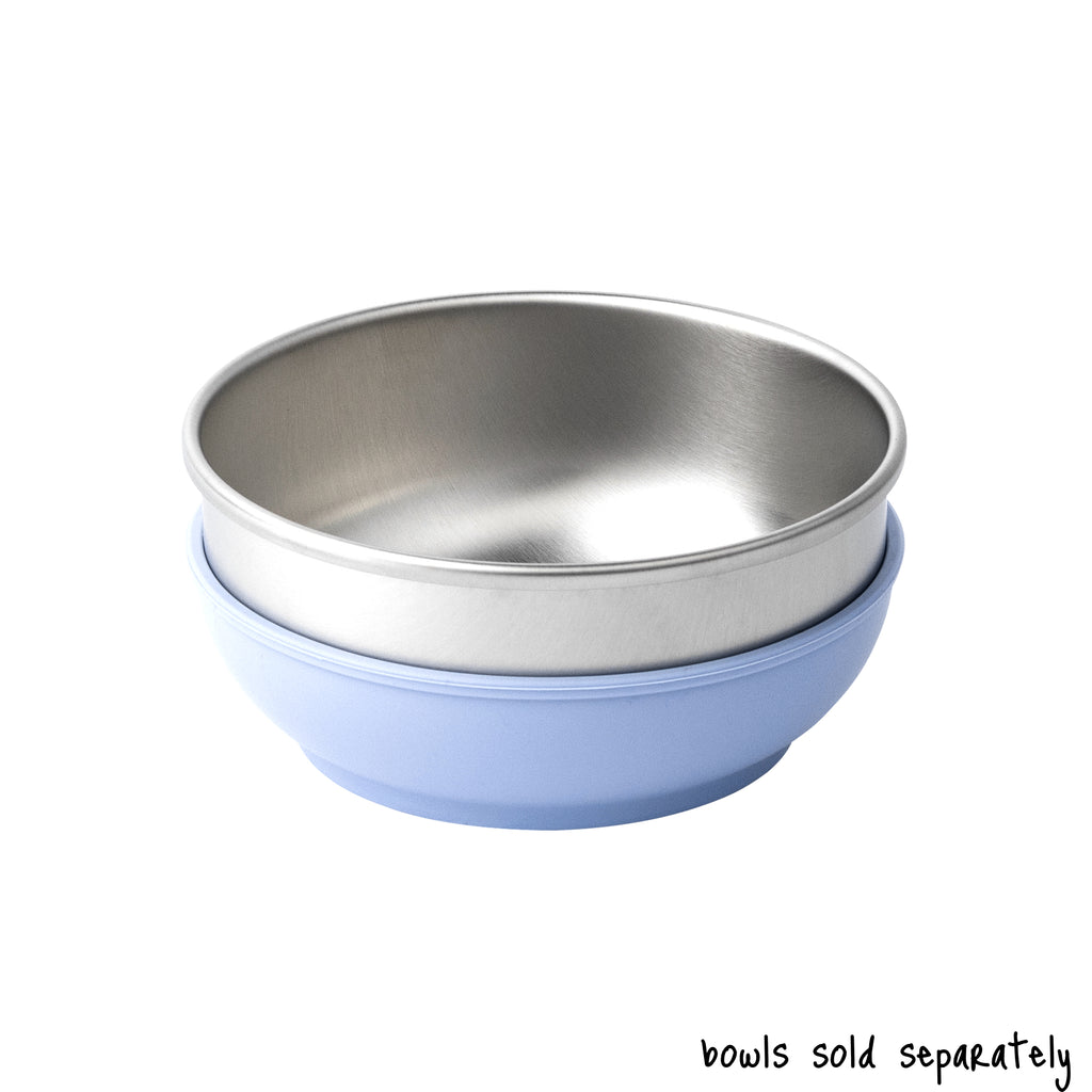 A single medium size Basis Pet stainless steel dog bowl in a light blue colored bowl cozy. Text reads "bowls sold separately".