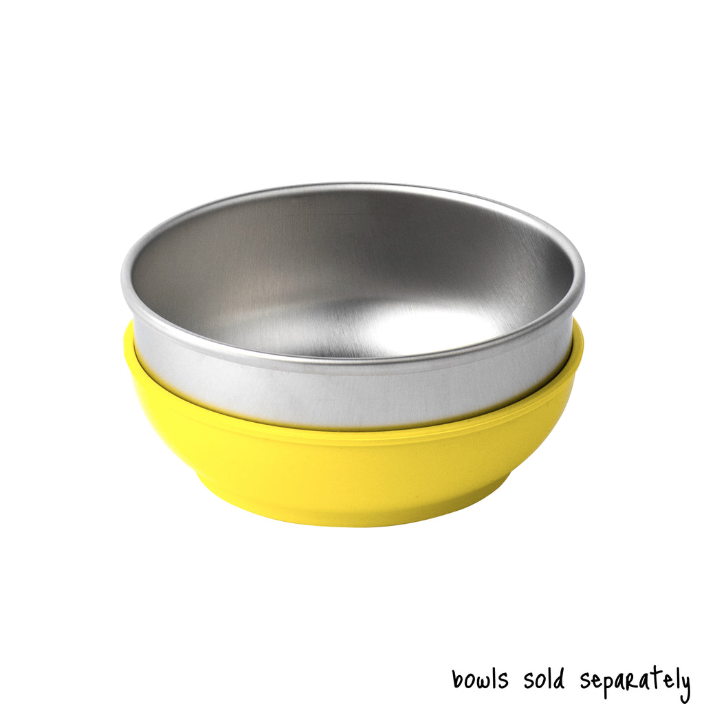 A single medium size Basis Pet stainless steel dog bowl in a light yellow colored bowl cozy. Text reads "bowls sold separately".