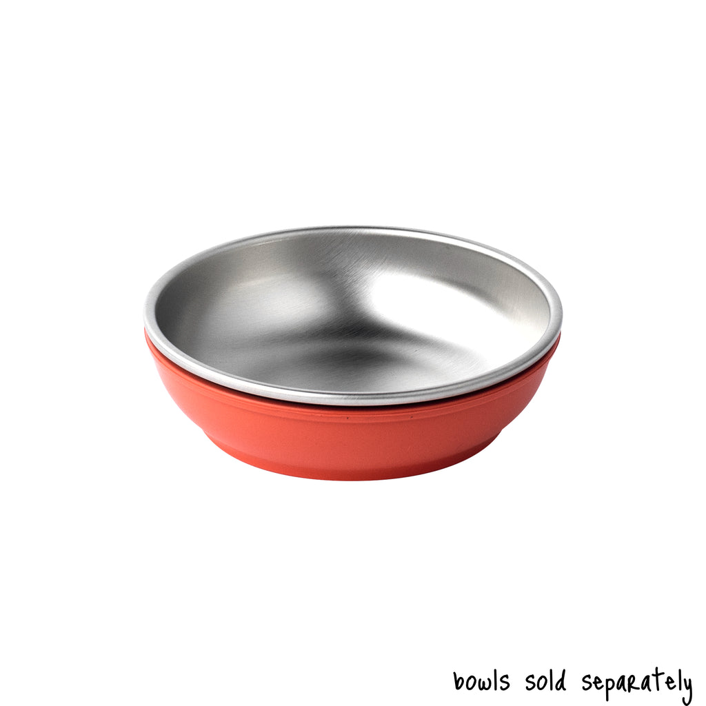 A single small size Basis Pet stainless steel dog bowl in a coral colored bowl cozy. Text reads "bowls sold separately".
