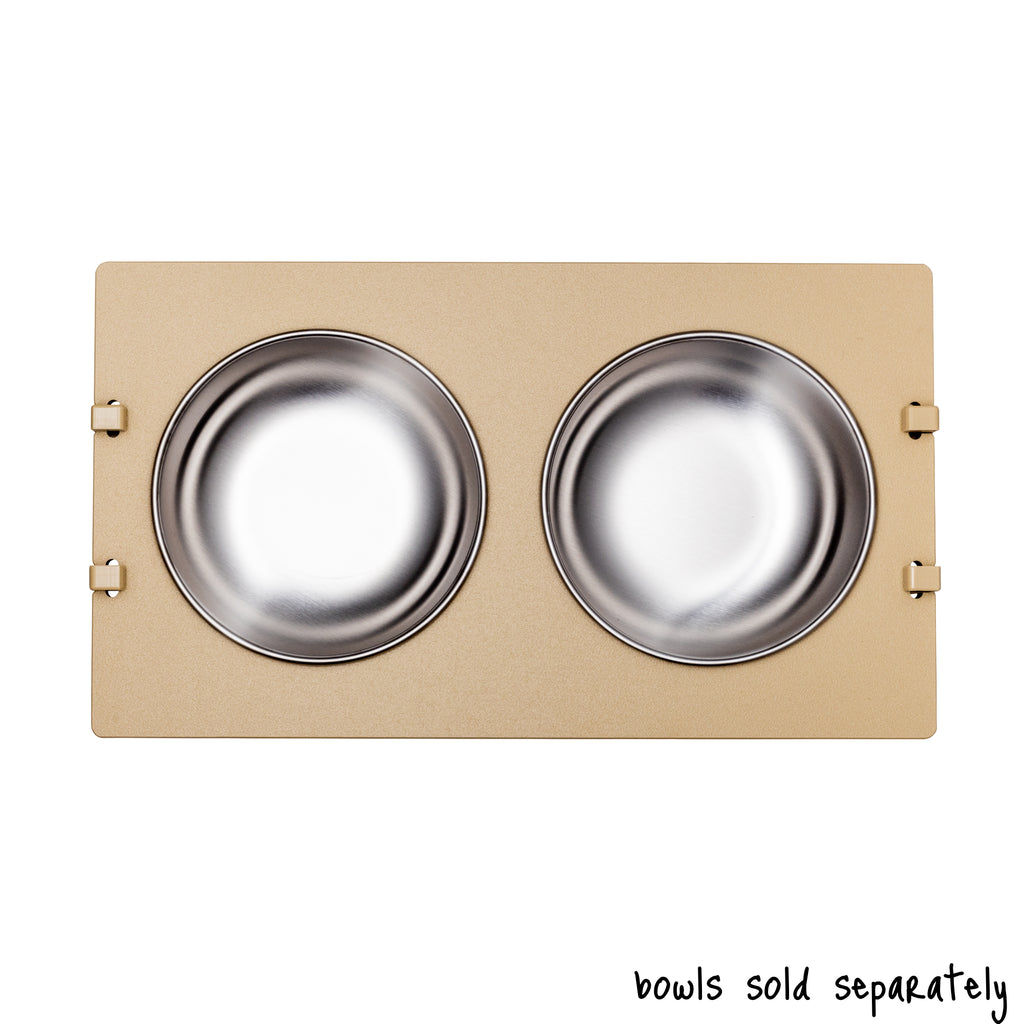 A double bowl Rise Pet Bowl Stand for medium dog bowls shown from above. Text reads "bowls sold separately".