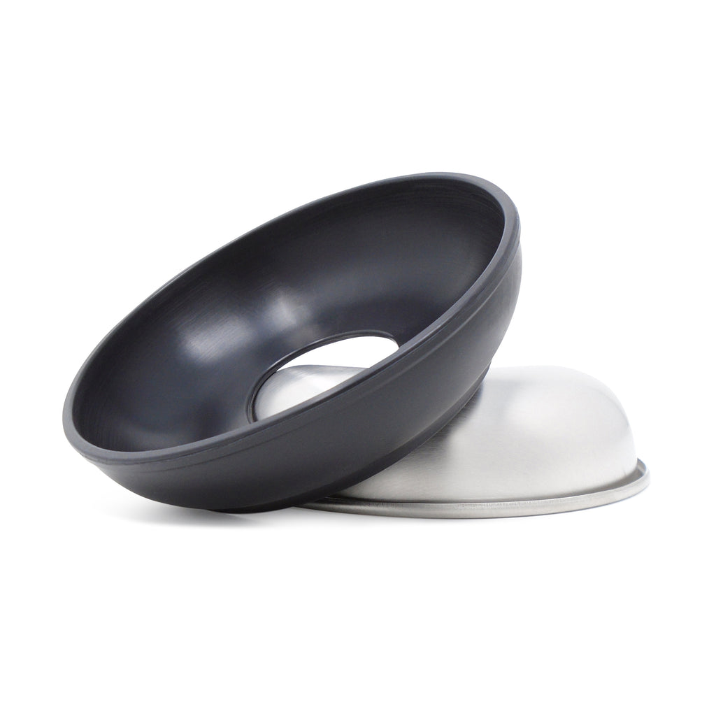 A single size small Basis Pet stainless steel dog bowl (same as the cat bowl) shown face down with a black bowl cozy resting  upright on the side of the bowl.